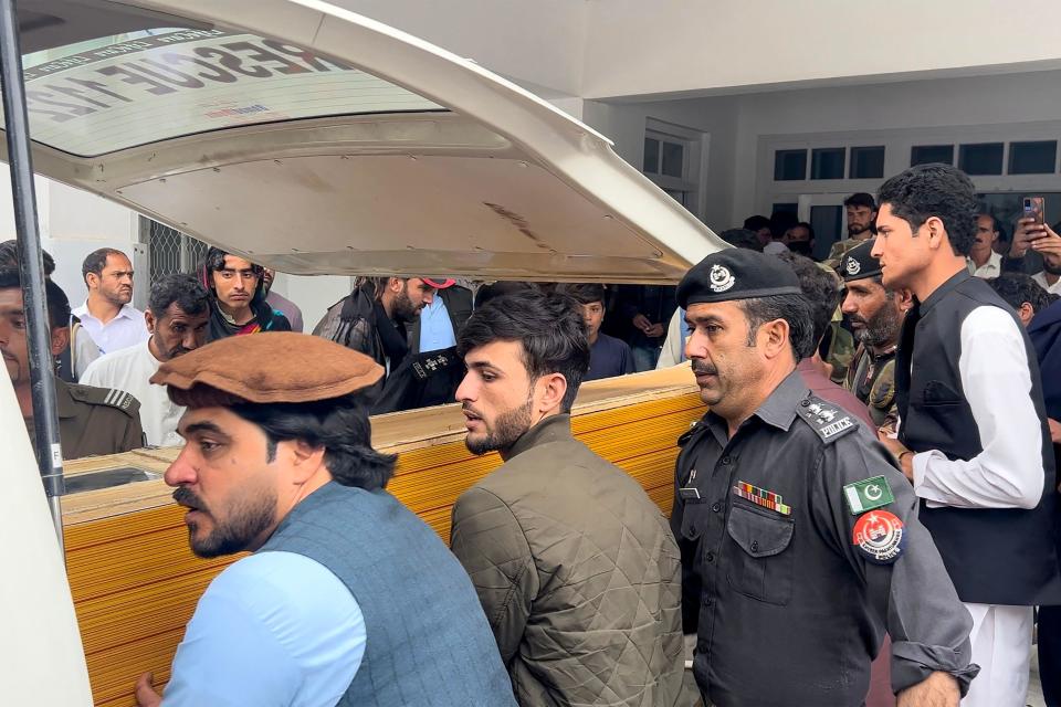 People carry a teacher's dead body into an ambulance from a hospital after a sectarian violence inside a school in Parachinar, in Kurram district on May 4, 2023. / Credit: Getty Images