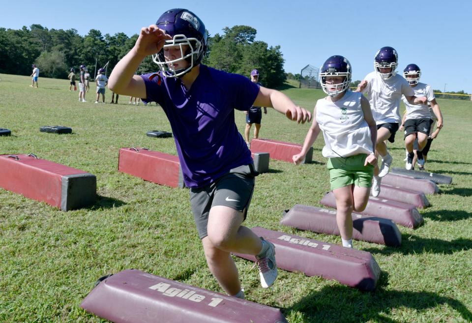 Caden Doherty, left, takes on an agility drill during an early season workout last Saturday on the school's practice field for the Bourne football squad.