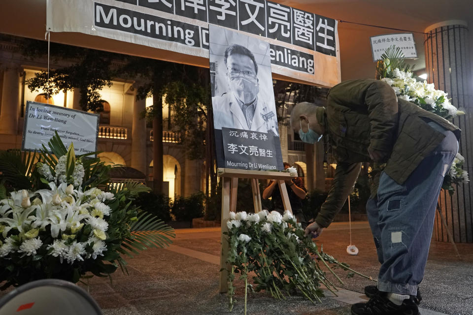 A man wearing mask, attends a vigil for Chinese doctor Li Wenliang, in Hong Kong, Friday, Feb. 7, 2020. The death of a young doctor who was reprimanded for warning about China's new virus triggered an outpouring Friday of praise for him and fury that communist authorities put politics above public safety. (AP Photo/Kin Cheung)