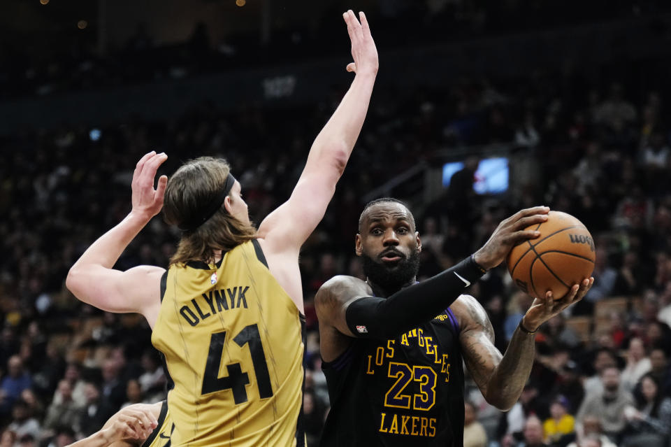 Los Angeles Lakers forward LeBron James (23) tries to get past Toronto Raptors forward Kelly Olynyk (41) during the second half of an NBA basketball game Tuesday, April 2, 2024, in Toronto. (Frank Gunn/The Canadian Press via AP)