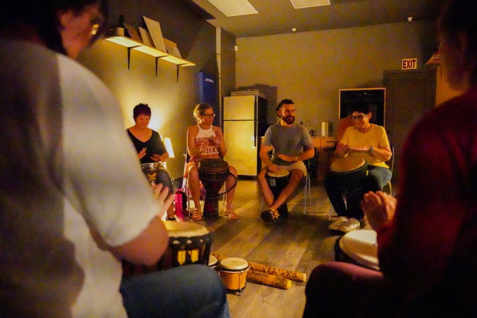 People participate in a drum circle at Grounded32 in Phoenix on July 25, 2022. The weekly gathering is intended to help release negative energy.