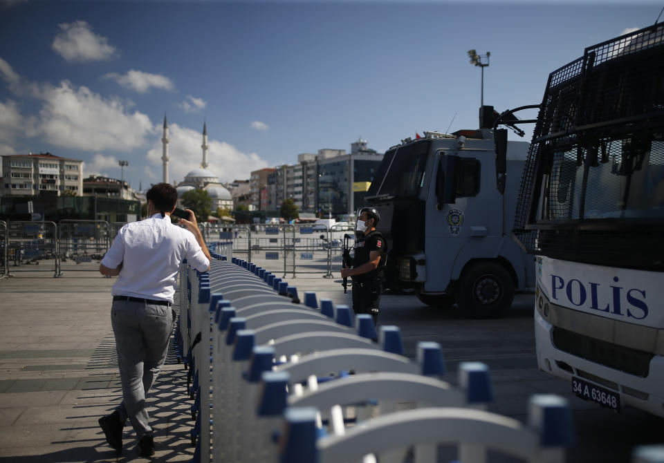 A Turkish police officer guards one of the entrances to a court in Istanbul, Friday, July 3, 2020, where the trial of 11 prominent human rights activists for terror-related charges and adjourned proceedings was continuing. The closely-watched case against Amnesty International's former Turkey chairman and 10 other activists heightened concerns about Turkey's treatment of human rights defenders and helped sour Turkey's relations with European nations, notably with Germany. (AP Photo/Emrah Gurel)