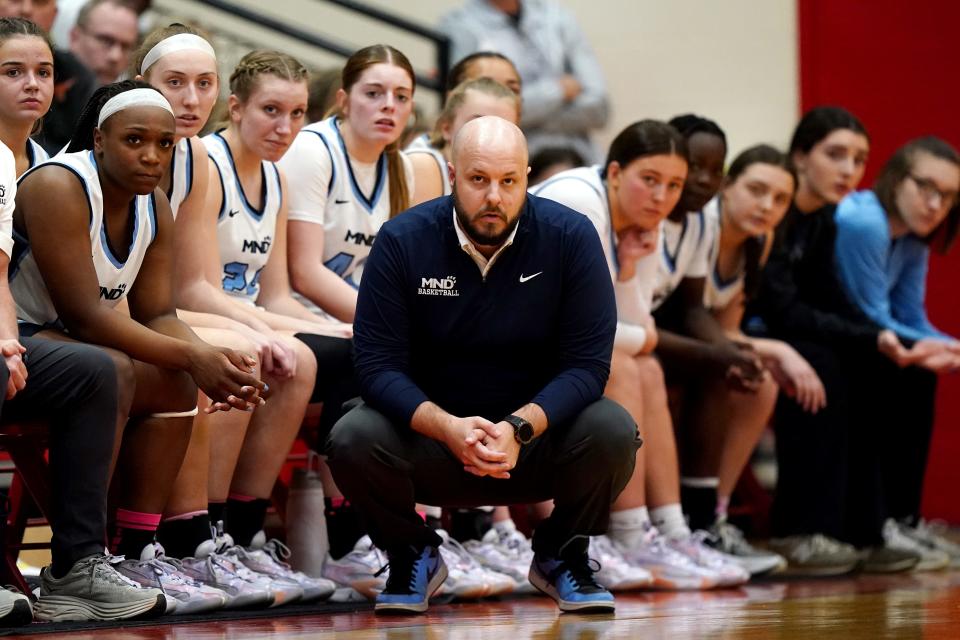 Mount Notre Dame Cougars head coach Drew Fladung observes play from the bench in the first half of an OHSAA Division I girls regional final game against the Springboro Panthers, Saturday, March 9, 2024, at Lakota West High School in West Chester Township, Ohio.