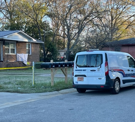 A police forensic van is parked outside a home on Enoch Avenue in Fayetteville where a man was shot and killed March 21, 2023.