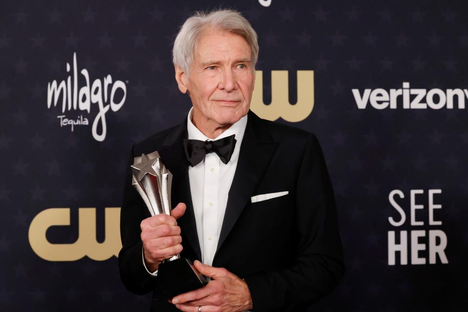 Harrison Ford, recipient of the Career Achievement Award at the Critics Choice Awards, poses with his trophy.