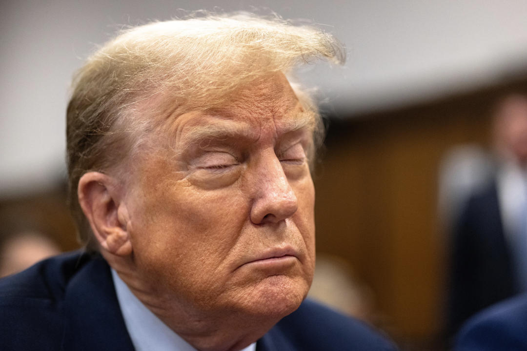 Former President Donald Trump sits at the defense table inside Manhattan Criminal Court.