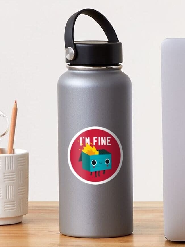 Reusable water bottle with a cartoon character sticker saying "I'M FINE." Placed on a desk