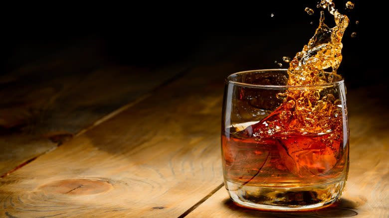 whiskey splashing in a glass