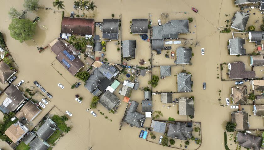 Floodwaters cover most of Pájaro Valley, Calif., Sunday, March 12, 2023. An atmospheric river storm broke through a levee along the Pájaro river inundating homes and businesses and leaving thousands of people without shelter. (Shae Hammond/Bay Area News Group via AP)