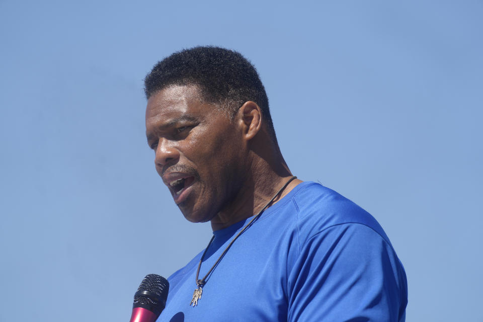 Georgia GOP Senate nominee Herschel Walker smiles during remarks during a campaign stop at Battle Lumber Co. on Thursday, Oct. 6, 2022, in Wadley, Ga. Walker's appearance was his first following reports that a woman who said Walker paid for her 2009 abortion is actually mother of one of his children - undercutting Walker's claims he didn't know who she was .(AP Photo/Meg Kinnard)