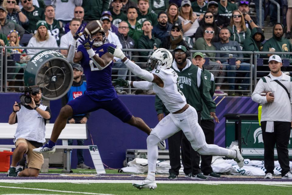 Washington wide receiever Ja'Lynn Polk, left, makes a reception against Michigan State defensive back Ameer Speed during the first half at Husky Stadium in Seattle on Saturday, Sept. 17, 2022.