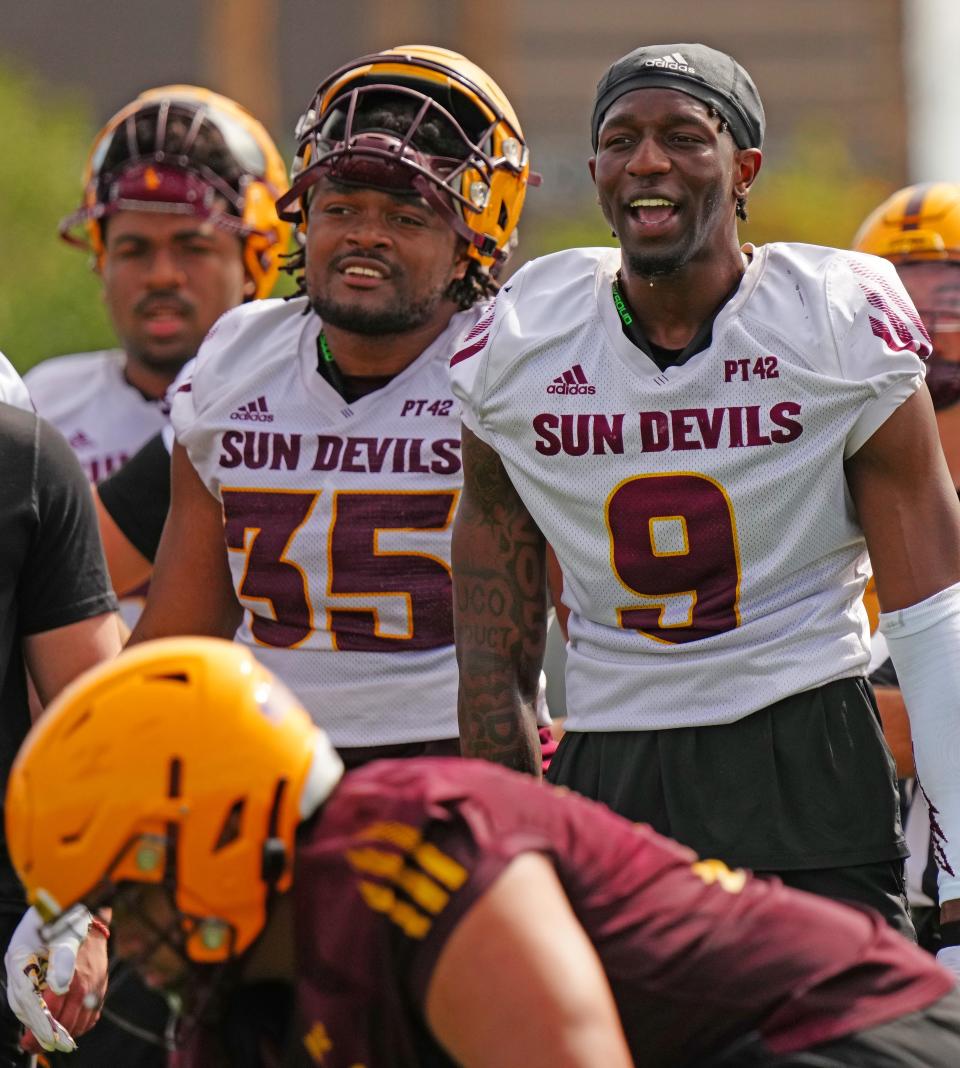 ASU defensive lineman B.J. Green (35) and defensive back Ro Torrence (9) cheer on teammates during a spring practice at the Kajikawa practice fields in Tempe on March 14, 2023.