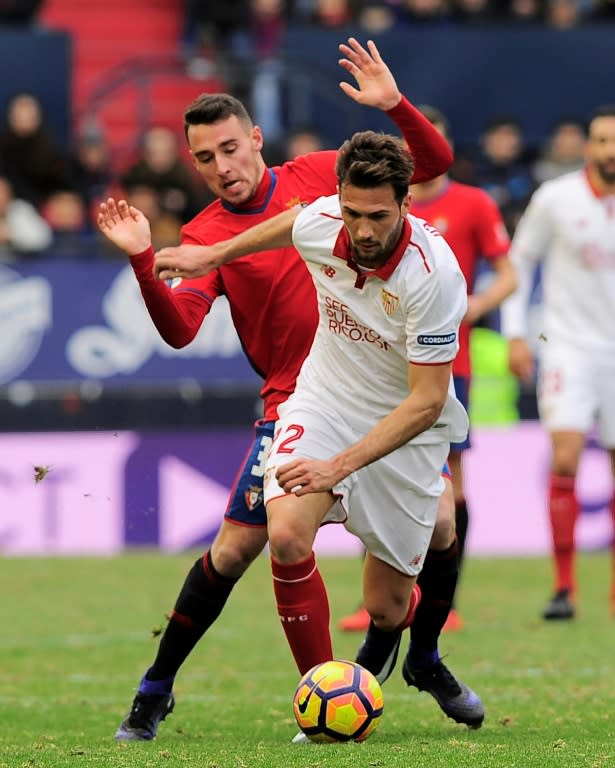 Sevilla's midfielder Franco Damian Vazquez (R) vies with Osasuna's midfielder Imanol Garcia (L) during the Spanish league football match CA Osasuna vs Sevilla FC at El Sadar stadium in Pamplona on January 22, 2017