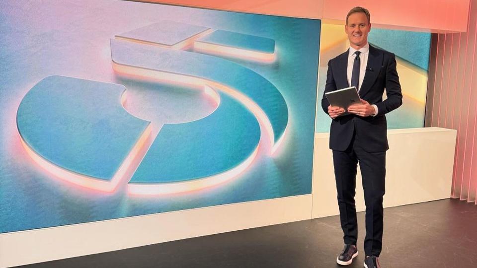 Dan Walker in a blue suit and blue trainers on Channel 5