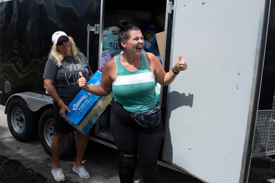 Synthia Fairman beams with happiness after learning that Chris Stewart has brought a bed for Synthia's father, Philip Fairman, whose home in the Twin Palms Estates neighborhood was flooded by Hurricane Ian. Stewart brought a trailer of donated goods to Fort Myers, Fla, on Monday, October 10, 2022 from Clewiston, Fla. for residents in the neighborhood. 