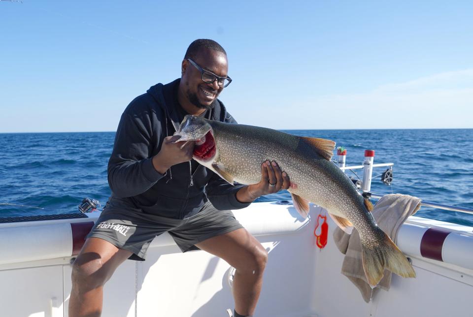 Marcus Stanford of Madison holds an 18.5-pound lake trout caught while fishing in June 2022 on Lake Michigan near Sheboygan. The DNR has decided to proceed with the process to allow commercial fishing for lake trout in Lake Michigan.