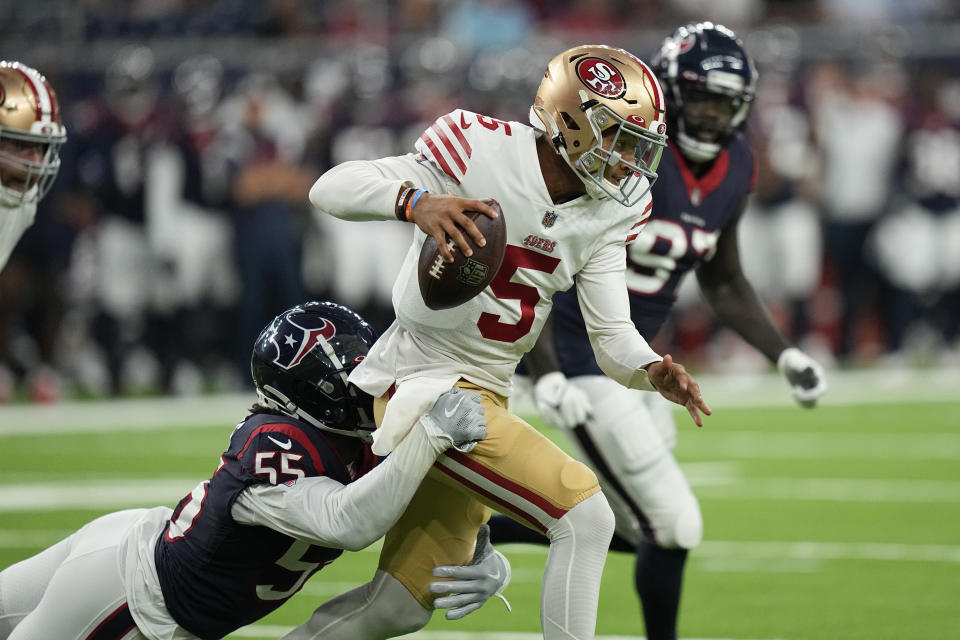 San Francisco 49ers quarterback Trey Lance (5) is sacked by Houston Texans defensive end Jerry Hughes (55) during the first half of an NFL football game Thursday, Aug. 25, 2022, in Houston. (AP Photo/David J. Phillip)