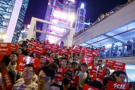 Demonstrators hold placards during a rally ahead of the G20 summit, urging the international community to back their demands for the government to withdraw a the extradition bill in Hong Kong