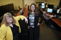 In this July 19, 2021, photo Amanda Crawford, right, and Nancy Rainosek, left, pose for a photo inside the state's Information Resources Command Center in Austin, Texas. (AP Photo/Chuck Burton)