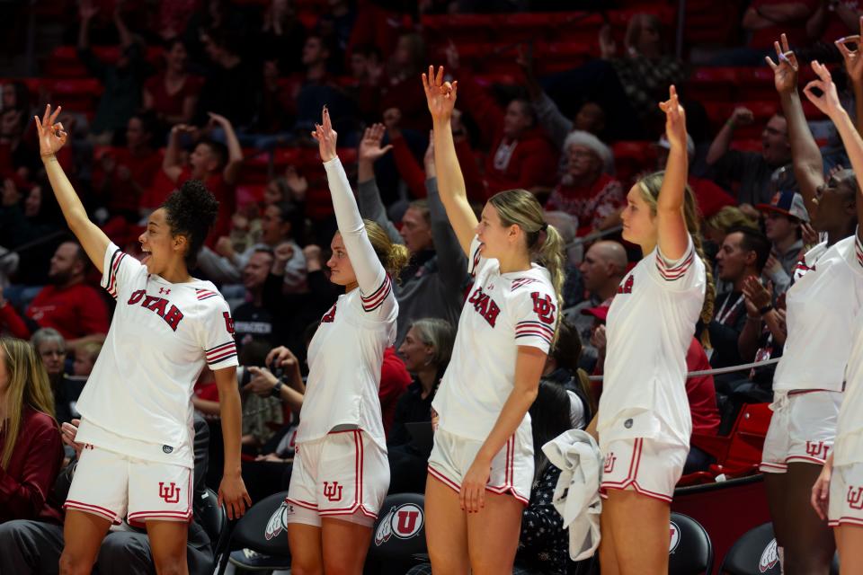 Utah Utes players cheer after a 3-point basket during the women’s college basketball game between the University of Utah and Weber State University at the Jon M. Huntsman Center in Salt Lake City on Thursday, Dec. 21, 2023. | Megan Nielsen, Deseret News