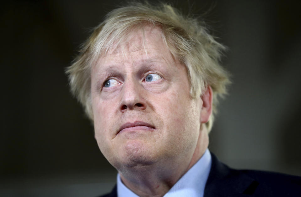 Britain's Prime Minister Boris Johnson attends a meeting with workers as he visits John Smedley Mill in Matlock, England, Thursday, Dec. 5, 2019. Britain is holding a general election a week from now and fractures are emerging within jittery political parties unsure how a volatile electorate will judge them. Conservative Prime Minister Boris Johnson and main opposition Labour Party leader Jeremy Corbyn both faced criticism of their moral character. (Hannah McKay/Pool Photo via AP)