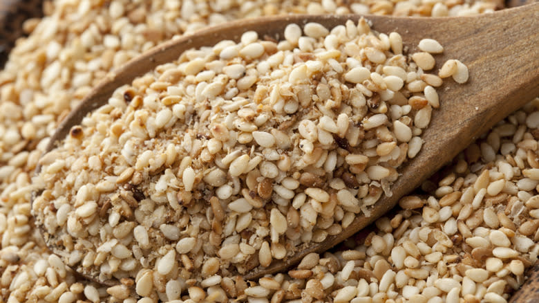 sesame seeds on wooden spoon