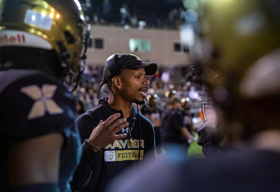 Xavier Prep head coach James Dockery talks to his players during a timeout in the second quarter of their second-round playoff game at Xavier College Preparatory High School in Palm Desert, Calif., Friday, Nov. 10, 2023.