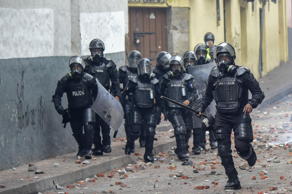 Riot police confront demonstrators during clashes in Quito as thousands march against Ecuadorean President Lenin Moreno's decision to slash fuel subsidies, on Oct. 9, 2019. (Photo: Mariana Suarez/AFP via Getty Images)