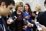 Sen. Lisa Murkowski, R-Alaska, center, listens to a reporter's question as she walks, on Capitol Hill, Monday, Sept. 24, 2018 in Washington. (AP Photo/Alex Brandon)