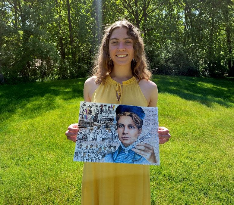 Hartland High School 2023 Graduate Breanna Zaborowski holds up her art piece.