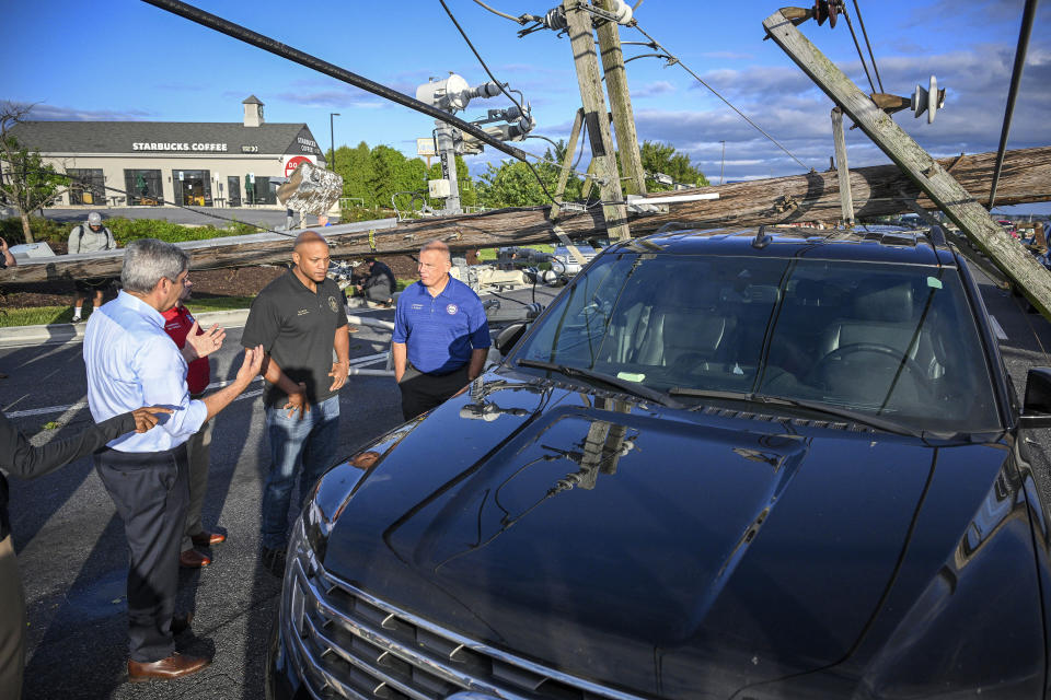 Maryland Gov. Wes Moore tours the damage along Route 140, Tuesday, Aug. 8, 2023 in Westminster, Md. where twenty power poles snapped durning Monday evening's storm trapping 34 cars and their occupants. (Jerry Jackson/The Baltimore Sun via AP)