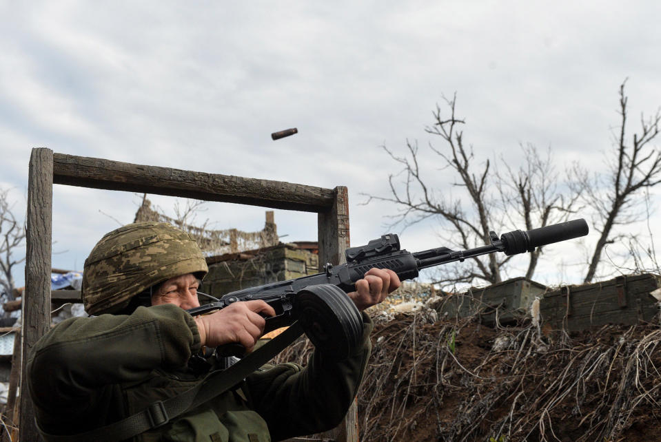 Image: A Ukrainian soldier attempts to shoot down a suspected drone near Donetsk. (Oleksandr Klymenko / Reuters)