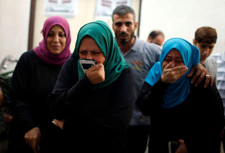 Relatives of a Palestinian, who was killed in an Israeli air strike, react at a hospital in the northern Gaza Strip October 17, 2018. REUTERS/Mohammed Salem