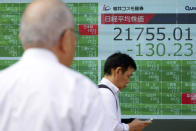 A man looks at an electronic stock board showing Japan's Nikkei 225 index at a securities firm in Tokyo Wednesday, Oct. 2, 2019. Asian shares are lower after U.S. stocks posted their worst loss in five weeks on Wednesday after a surprisingly limp report on the nation’s manufacturing that stirred worries about the economic outlook.(AP Photo/Eugene Hoshiko)