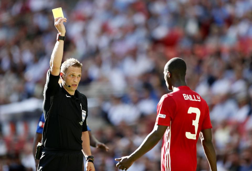 Football Soccer Britain - Leicester City v Manchester United - FA Community Shield - Wembley Stadium - 7/8/16 Manchester United's Eric Bailly is shown a yellow card by referee Craig Pawson Action Images via Reuters / John Sibley Livepic EDITORIAL USE ONLY. No use with unauthorized audio, video, data, fixture lists, club/league logos or "live" services. Online in-match use limited to 45 images, no video emulation. No use in betting, games or single club/league/player publications. Please contact your account representative for further details.