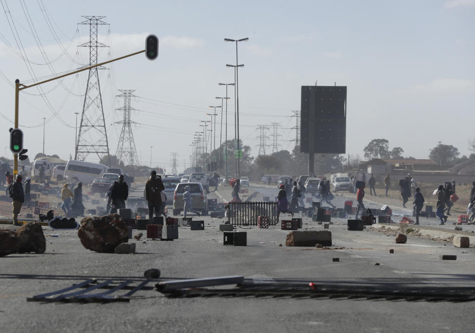 A road is barricaded in Soweto near Johannesburg, Tuesday July 13, 2021 as ongoing looting and violence continues. South Africa's rioting continued Tuesday with the death toll rising to 32 as police and the military struggle to quell the violence in Gauteng and KwaZulu-Natal provinces. The violence started in various parts of KwaZulu-Natal last week when Zuma began serving a 15-month sentence for contempt of court. (AP Photo/Themba Hadebe)