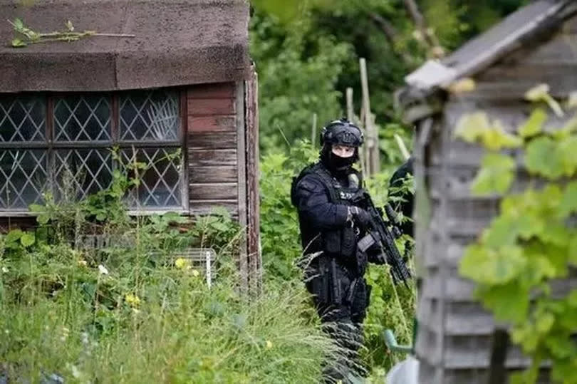 Armed police use bolt cutters to gain access to the Enfield Council, Cooks Hole Allotment site in Enfield, in the hunt for Kyle Clifford