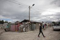 Man walks along a street in Caradeux, a camp for people displaced by the January 2010 earthquake, in Port-au-Prince