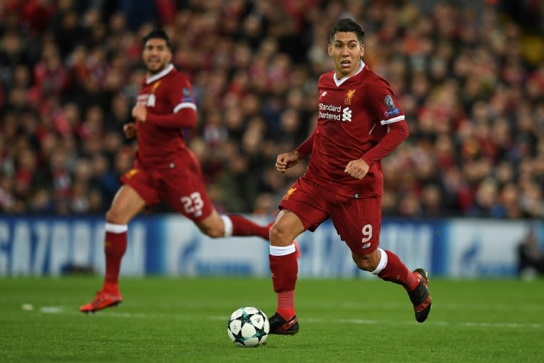 Liverpool's Roberto Firmino (R) runs with the ball during their match against Spartak Moscow in Liverpool, north-west England on December 6, 2017