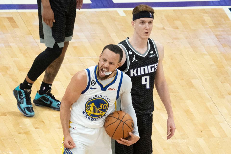 Game 7: Golden State Warriors guard Stephen Curry (30) celebrates in front of Sacramento Kings guard Kevin Huerter (9) during the fourth quarter. Curry scored a Game 7-record 50 points in the Warriors' victory.