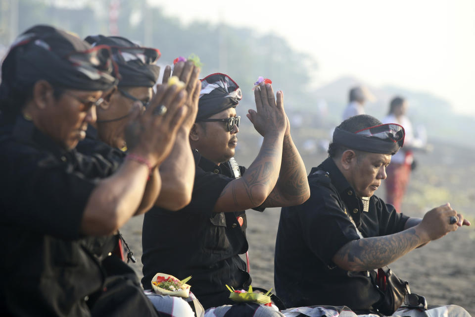 Balinese traditional guards called "pecalang"participate in a purification ceremony on Melasti at Padanggala beach in Bali, Indonesia on Friday, March 8, 2024. Melasti is part of the six-day long Balinese Hindu New Year, where devout perform rituals as an act of symbolic cleansing. (AP Photo/Firdia Lisnawati)