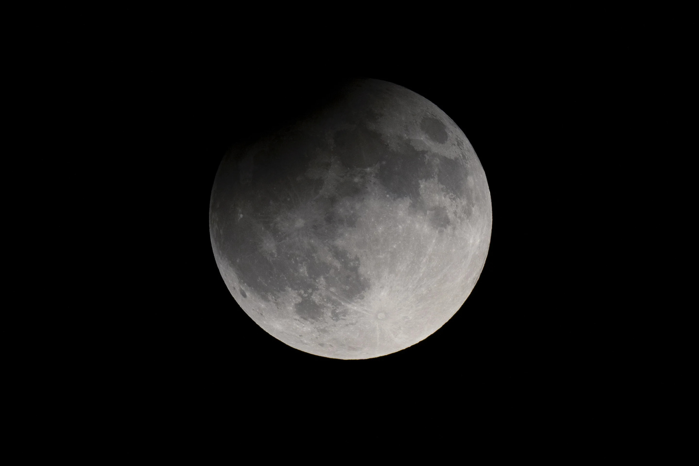 A partial eclipse darkens a rising supermoon in Nashville on Tuesday.