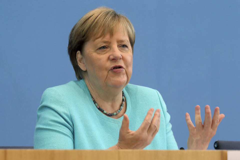 German Chancellor Angela Merkel, gestures, as she holds her annual summer news conference in Berlin, Germany, Thursday, July 22, 2021. Merkel said Thursday that new coronavirus infections in Germany are once again rising at worrying speed. She appealed to her compatriots to get vaccinated and persuade others to do so. (Wolfgang Kumm/dpa via AP)