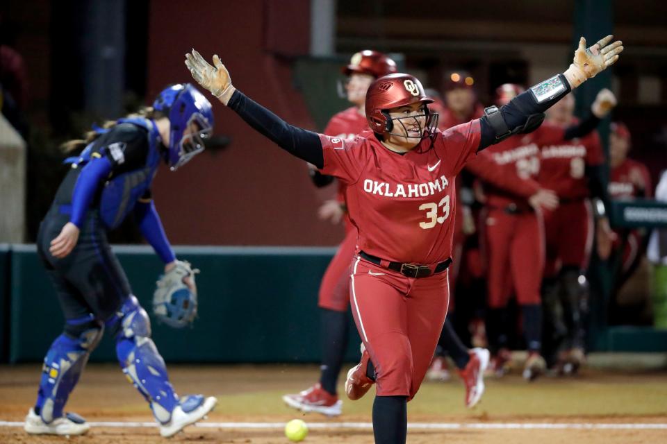 OU's Alyssa Brito (33) celebrates after getting hit by a pitch and sending a run home to end the game in the fifth inning of an 8-0 win against South Dakota State on Monday at Marita Hynes Field in Norman.