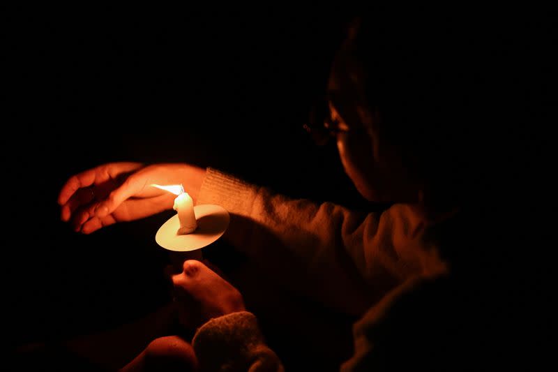 People gather for a candlelight vigil on Bondi Beach to pay respects to the victims of a fatal stabbing attack at a shopping centre in Sydney