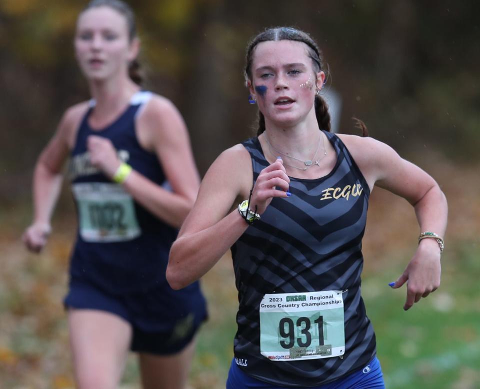 East Canton's Audrey Wade (right) runs to a fifth-place finish in the Division III girls race at last fall's regional cross country meet in Boardman.