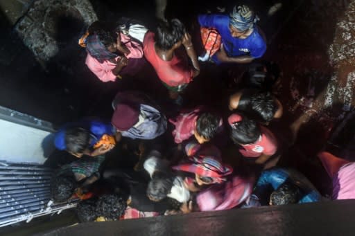 Villagers enter a building to take shelter in Bakkhali, India as Cyclone Bulbul approached