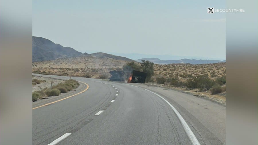 Photo of the big rig carrying lithium batteries that overturned and caught fire, causing a massive traffic backup on the I-15 Freeway on July 27, 2024. (SB County Fire)