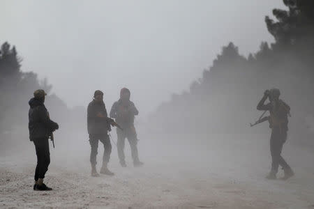 Free Syrian Army fighters carry their weapons as they stand on the outskirts of the Islamic State-controlled northern Syrian town of al-Bab, Syria February 4, 2017. Picture taken February 4, 2017. REUTERS/Khalil Ashawi