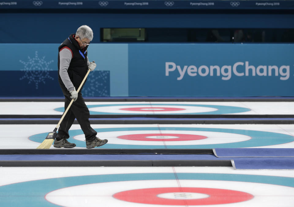 <p>A man sweeps the sheets before the start of the curling mixed doubles semi-final match at the 2018 Winter Olympics in Gangneung, South Korea, Monday, Feb. 12, 2018. (AP Photo/Aaron Favila) </p>